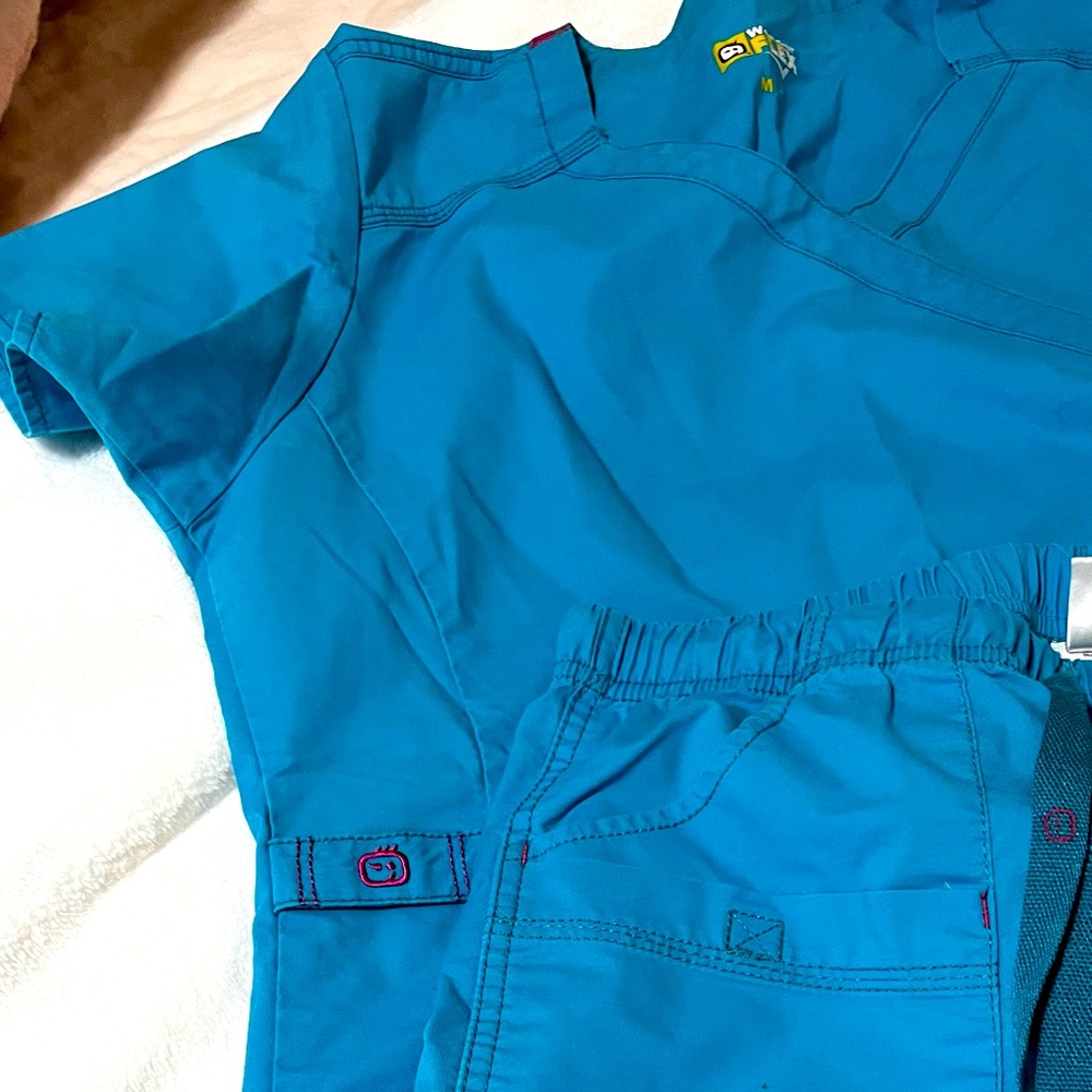Bright Teal blue with pink accents Wonderflex scrubs
